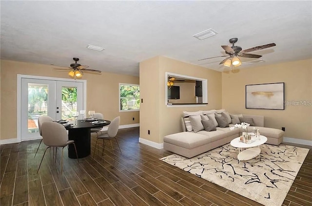 living room with french doors, dark wood-type flooring, and ceiling fan