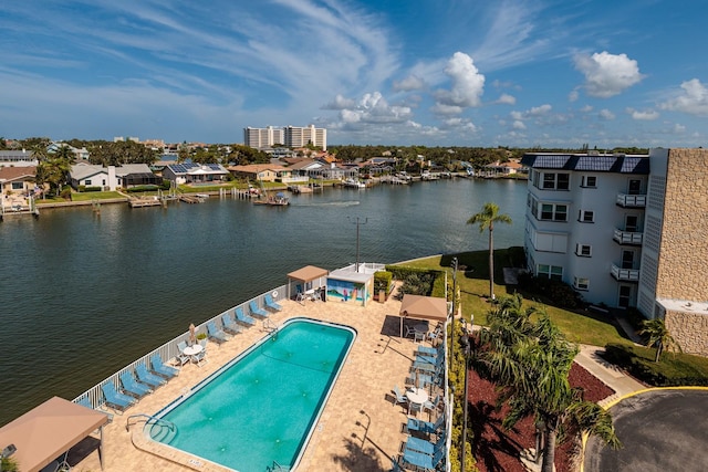 view of pool featuring a water view and a patio area