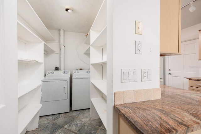 clothes washing area featuring separate washer and dryer