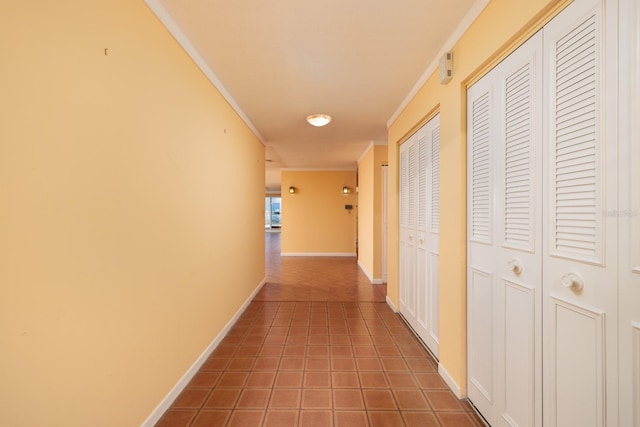 hall with tile patterned flooring and ornamental molding