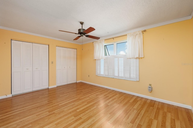 unfurnished bedroom featuring ornamental molding, a textured ceiling, hardwood / wood-style floors, and ceiling fan