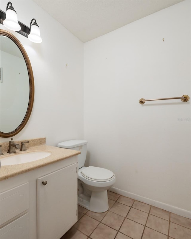 bathroom with tile patterned floors, toilet, and vanity