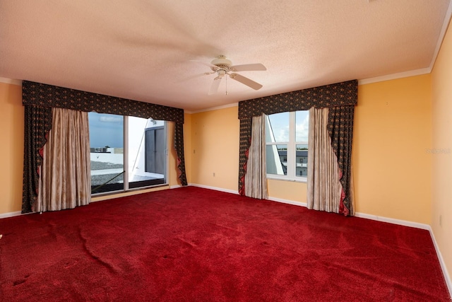 carpeted spare room featuring ceiling fan, crown molding, and a textured ceiling