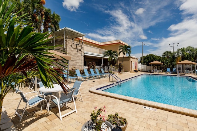 view of swimming pool with a gazebo and a patio