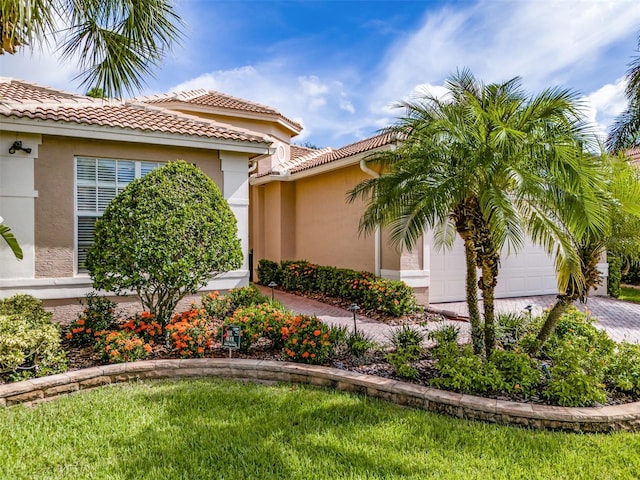 view of home's exterior with a yard and a garage