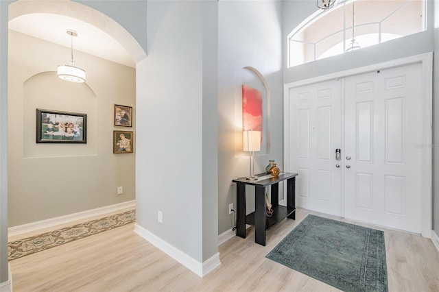 entrance foyer with light hardwood / wood-style flooring and a high ceiling