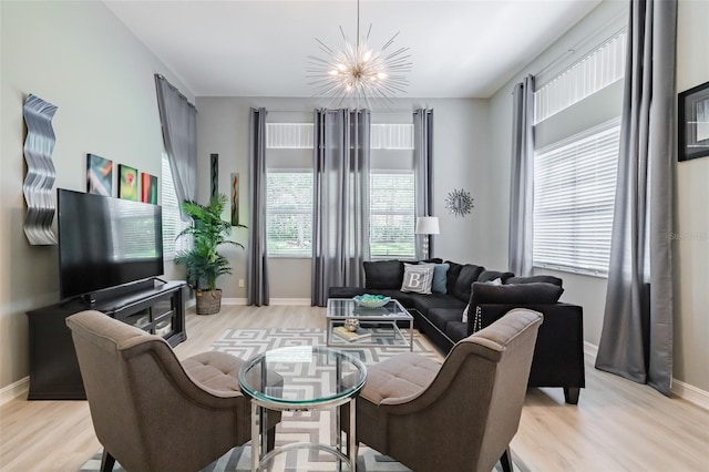 living room featuring light hardwood / wood-style flooring and a chandelier