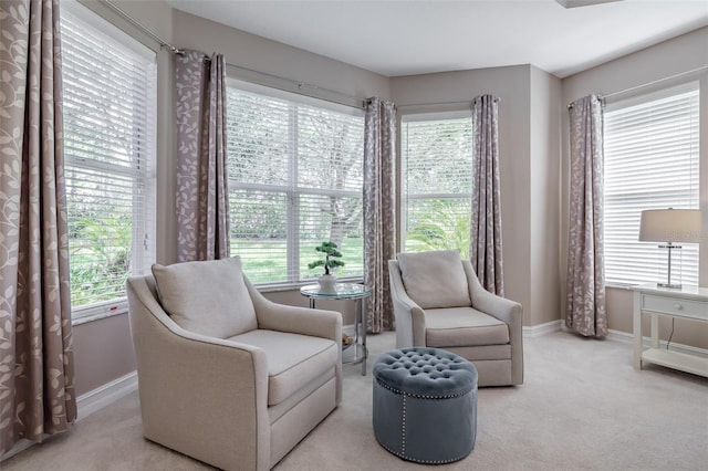 living area featuring light colored carpet and plenty of natural light