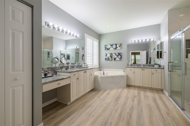 bathroom featuring vanity, separate shower and tub, and plenty of natural light