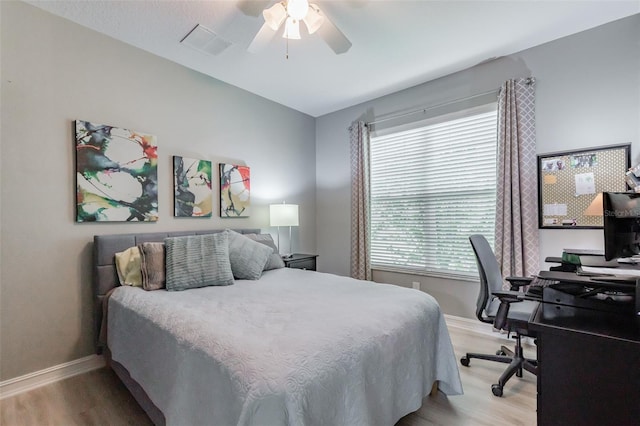 bedroom with ceiling fan and light hardwood / wood-style flooring