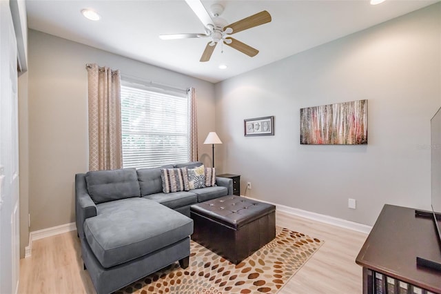 living room featuring ceiling fan and light hardwood / wood-style flooring