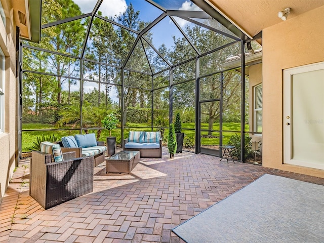 view of patio featuring an outdoor living space and a lanai