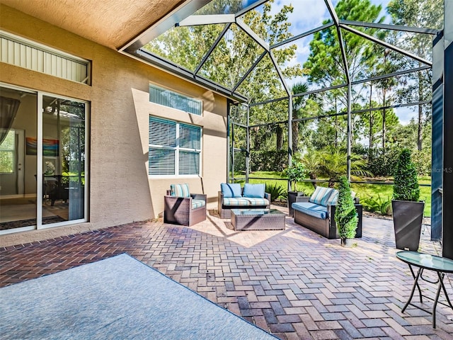 view of patio / terrace featuring outdoor lounge area and glass enclosure