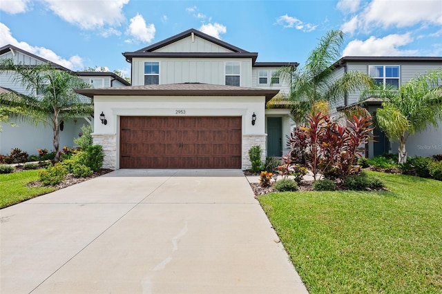 view of front of house with a front yard and a garage