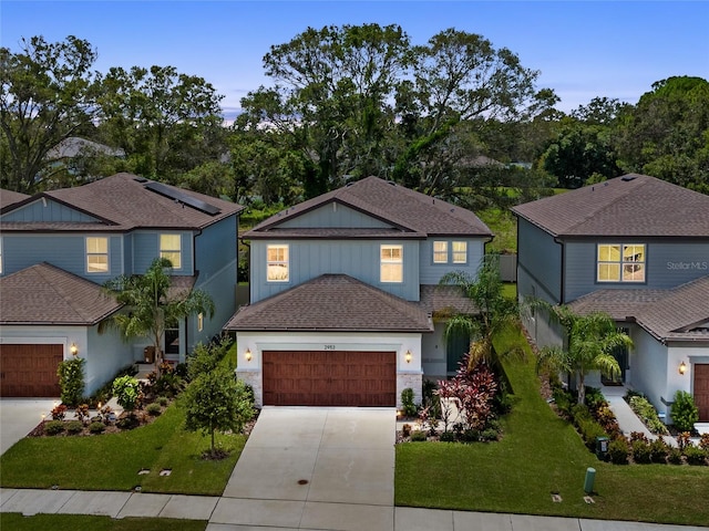 view of front of property with a front lawn and a garage