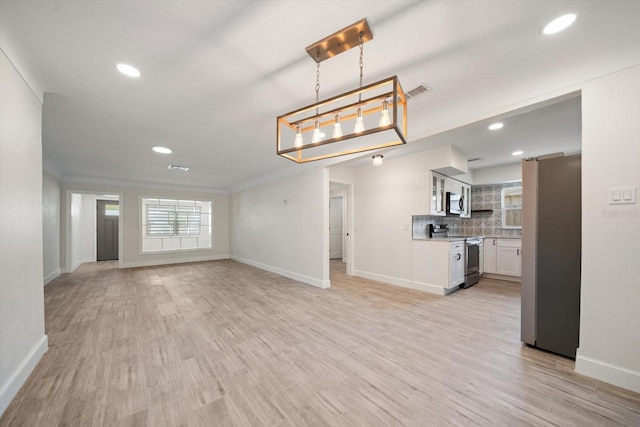 unfurnished living room with recessed lighting, light wood-type flooring, and baseboards