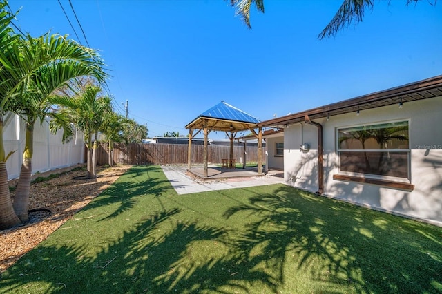 view of yard featuring a fenced backyard, a patio, and a gazebo