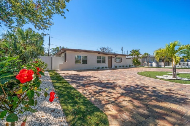 view of front of house featuring fence and stucco siding