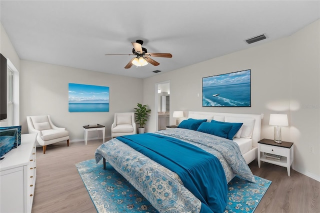 bedroom featuring a ceiling fan, baseboards, visible vents, and light wood finished floors