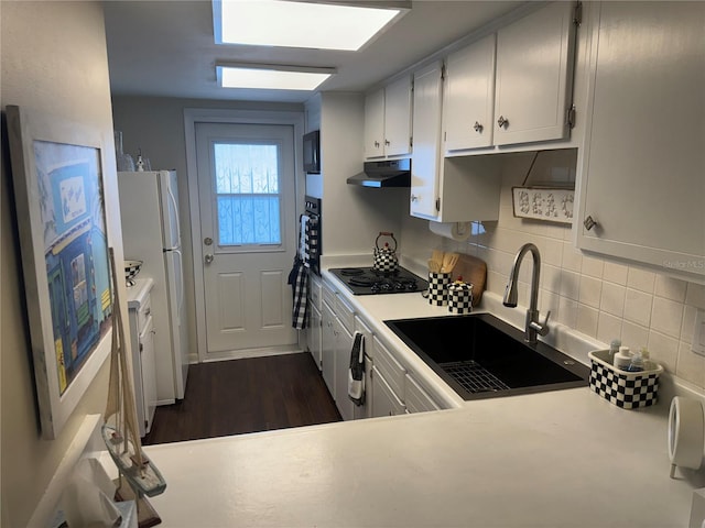 kitchen featuring white cabinets, black electric stovetop, dark hardwood / wood-style floors, and sink