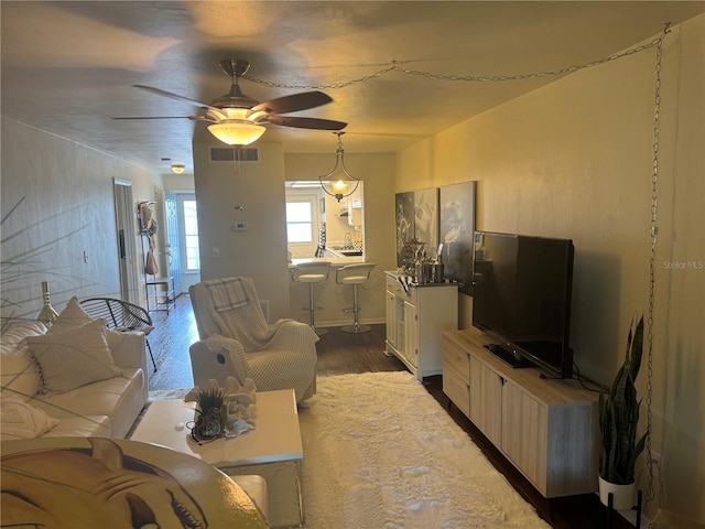 living room featuring hardwood / wood-style floors and ceiling fan