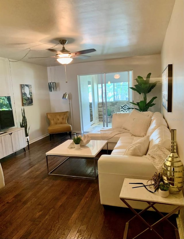 living room featuring dark hardwood / wood-style flooring and ceiling fan