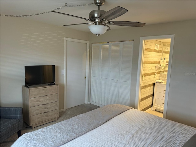 bedroom featuring light carpet, a closet, ensuite bathroom, and ceiling fan