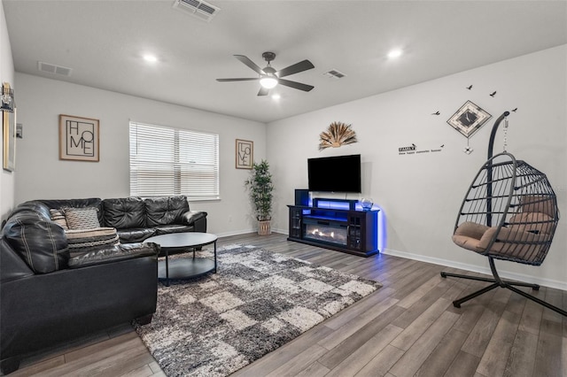 living room with ceiling fan and wood-type flooring