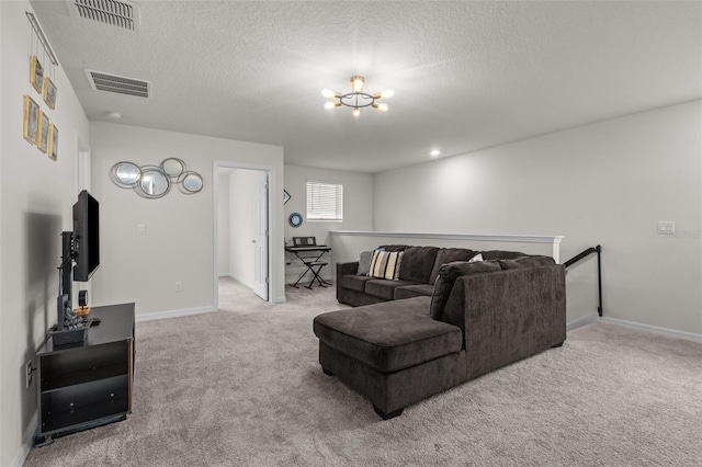 living room with an inviting chandelier, a textured ceiling, and carpet flooring