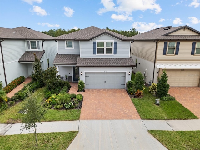 view of front of property featuring a front lawn and a garage