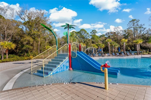 view of pool with a playground