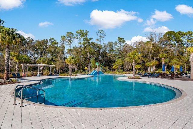 view of swimming pool featuring a patio and a pergola