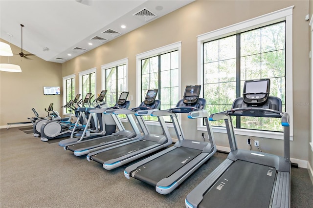 gym featuring ceiling fan and vaulted ceiling