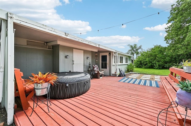 wooden deck featuring a lawn