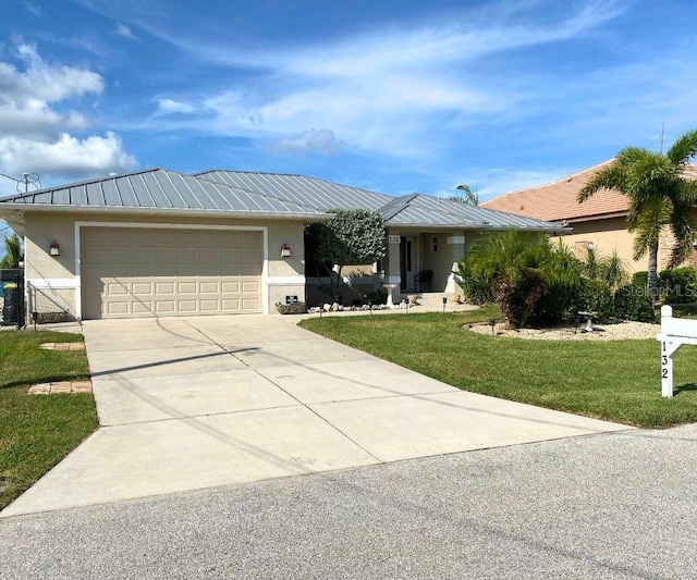 view of front of home with a garage and a front yard