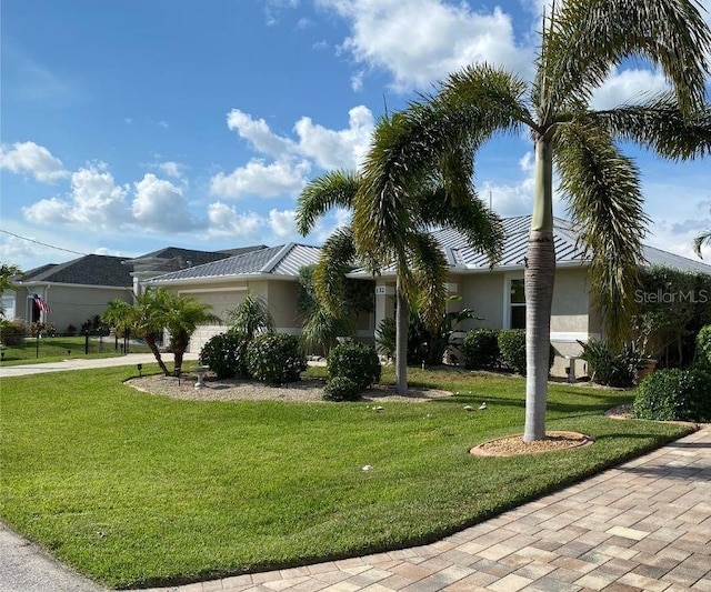 132 Peckham St SE, Port Charlotte, FL 33952 - view of front of house with stucco siding, an attached garage, a front lawn, and driveway