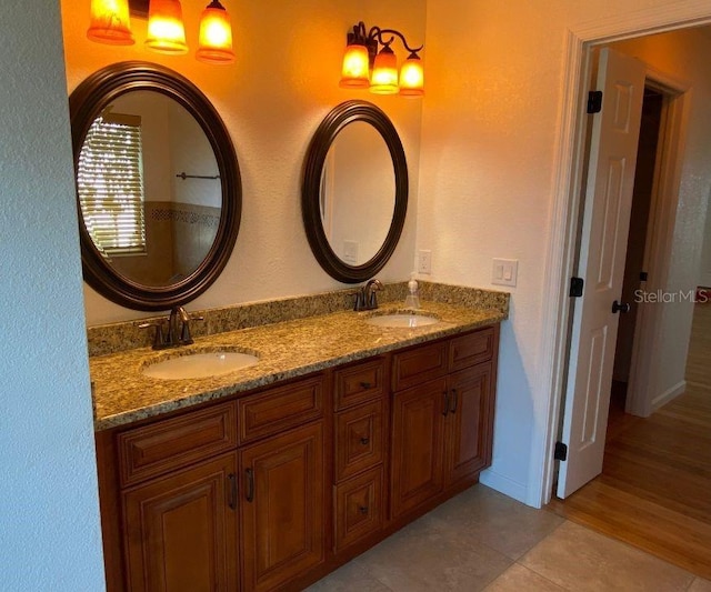 132 Peckham St SE, Port Charlotte, FL 33952 - bathroom with double vanity, tile patterned flooring, a sink, and baseboards
