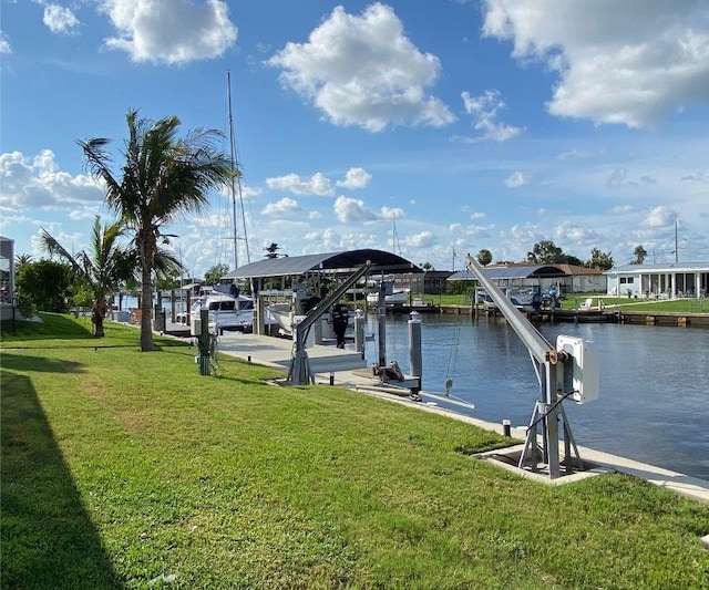 dock area with a water view and a yard