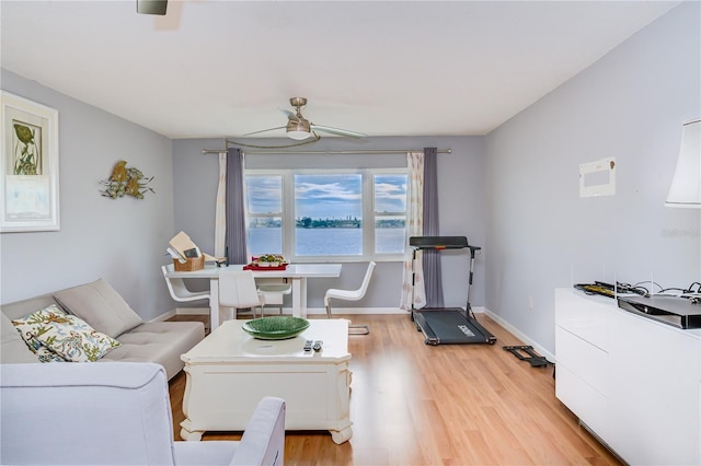 living room featuring light hardwood / wood-style flooring and ceiling fan