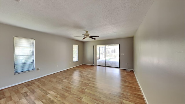 unfurnished room featuring a textured ceiling, light hardwood / wood-style floors, and ceiling fan