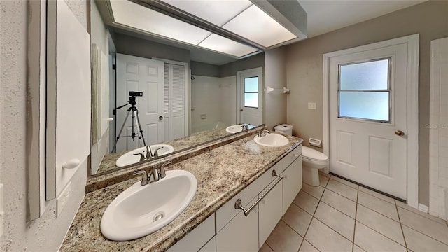 bathroom featuring tile patterned floors, vanity, and toilet