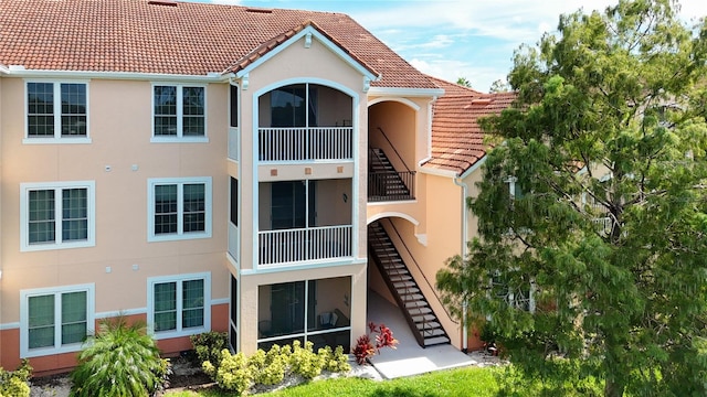 back of property featuring a balcony