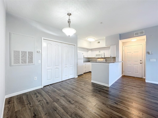 kitchen with white cabinetry, dark wood-type flooring, white appliances, decorative light fixtures, and sink