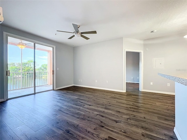 spare room featuring dark wood-type flooring and ceiling fan