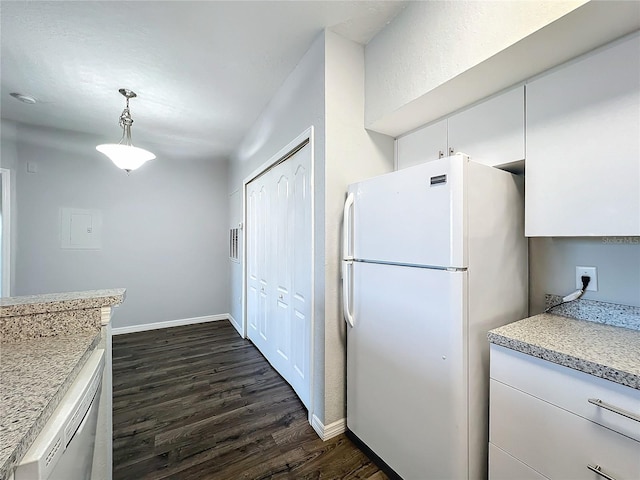 kitchen with hanging light fixtures, white cabinetry, white refrigerator, dark hardwood / wood-style flooring, and stainless steel dishwasher