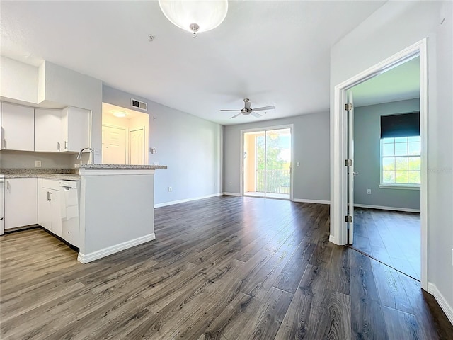 kitchen with ceiling fan, kitchen peninsula, white cabinetry, dishwasher, and dark hardwood / wood-style flooring