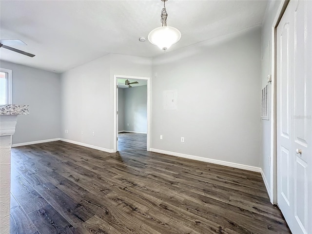 empty room featuring ceiling fan and dark hardwood / wood-style flooring