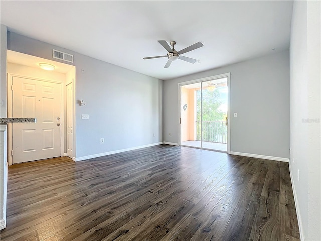 empty room featuring ceiling fan and dark wood-type flooring