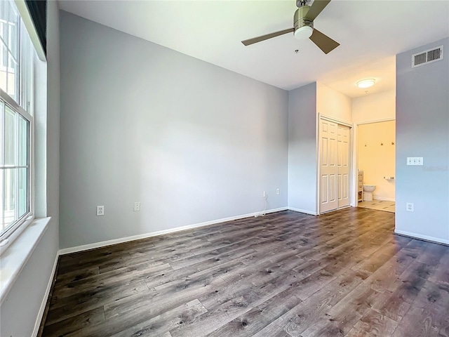 spare room featuring ceiling fan, hardwood / wood-style flooring, and a wealth of natural light