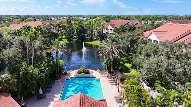 view of swimming pool featuring a water view and a patio area